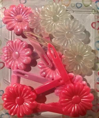 Shades of pink and clear flower barrettes with sheen