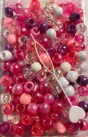 Pinks, purple,white and clear hair beads with sheen.