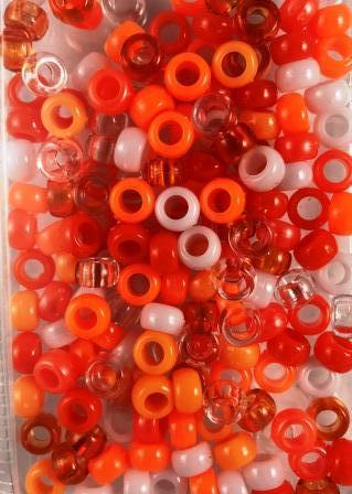 shades of orange, white, and clear hair beads